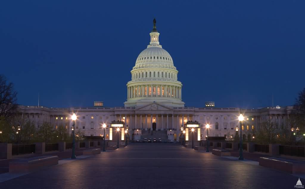 Front Facade Of United States Capitol At Night