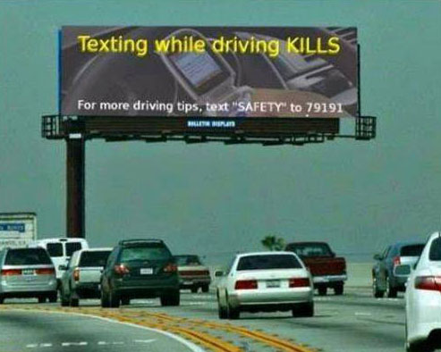 Funny Sign Board – Texting while driving kills