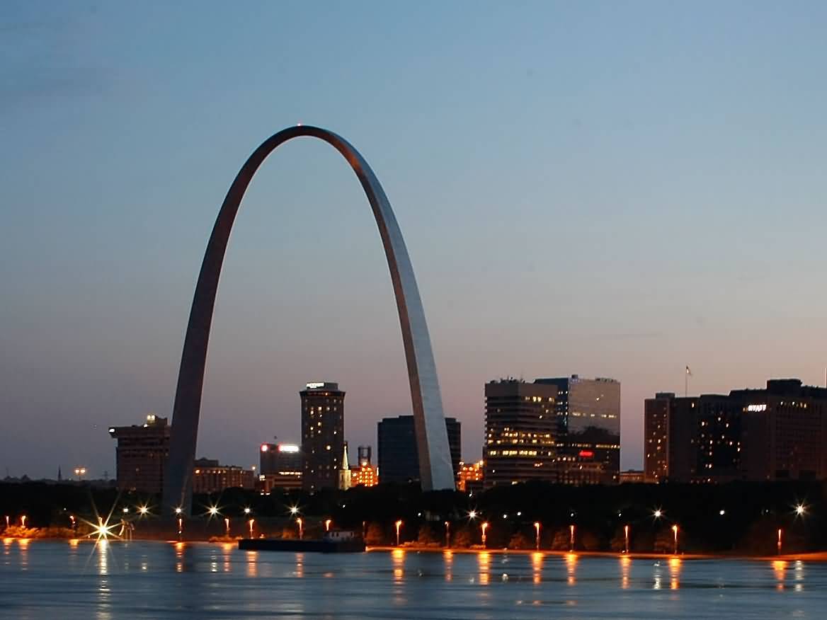 Gateway Arch In Front Of Mississippi River At Dusk