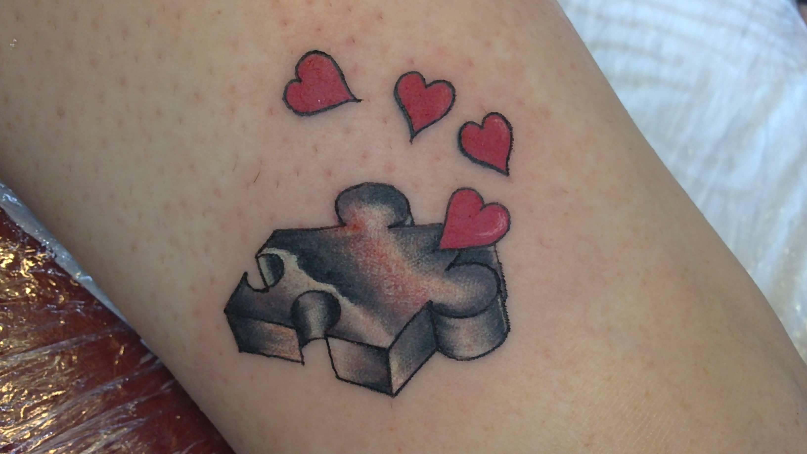 Hearts Puzzle Tattoo On Arm