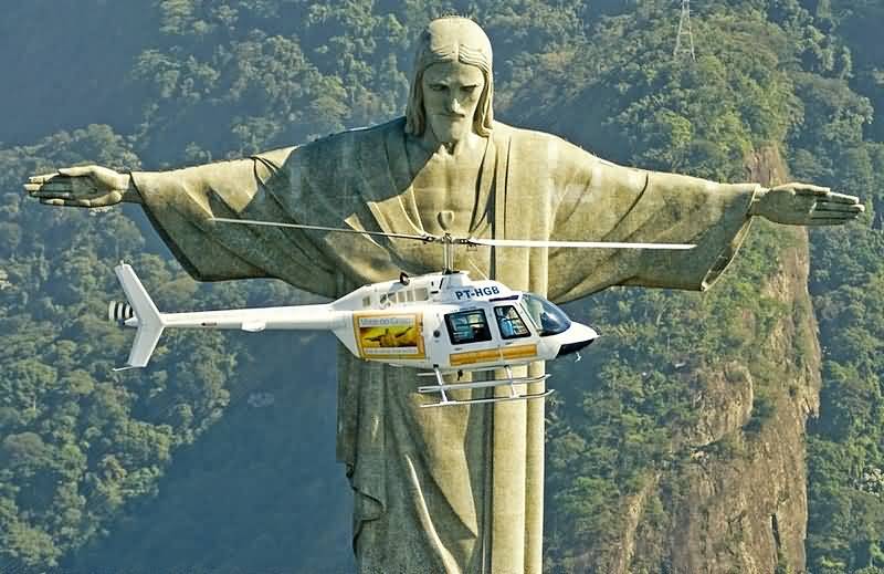 Helicopter Flying In Front Of The Christ The Redeemer Statue