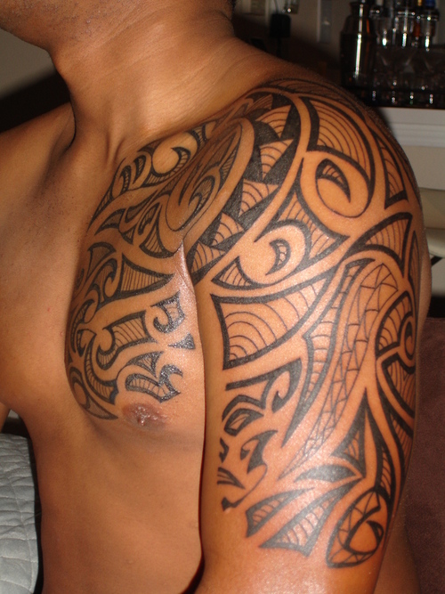 Impressive Maori Tattoo On Sleeve And Chest