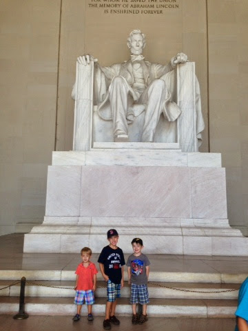 Kids Posing For Photograph In Front Of Statue Inside The Lincoln Memorial