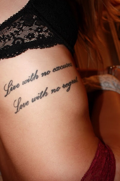 Love Quote Tattoo On Girl Rib Cage