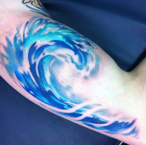 Lovely Water Waves Tattoo On Biceps