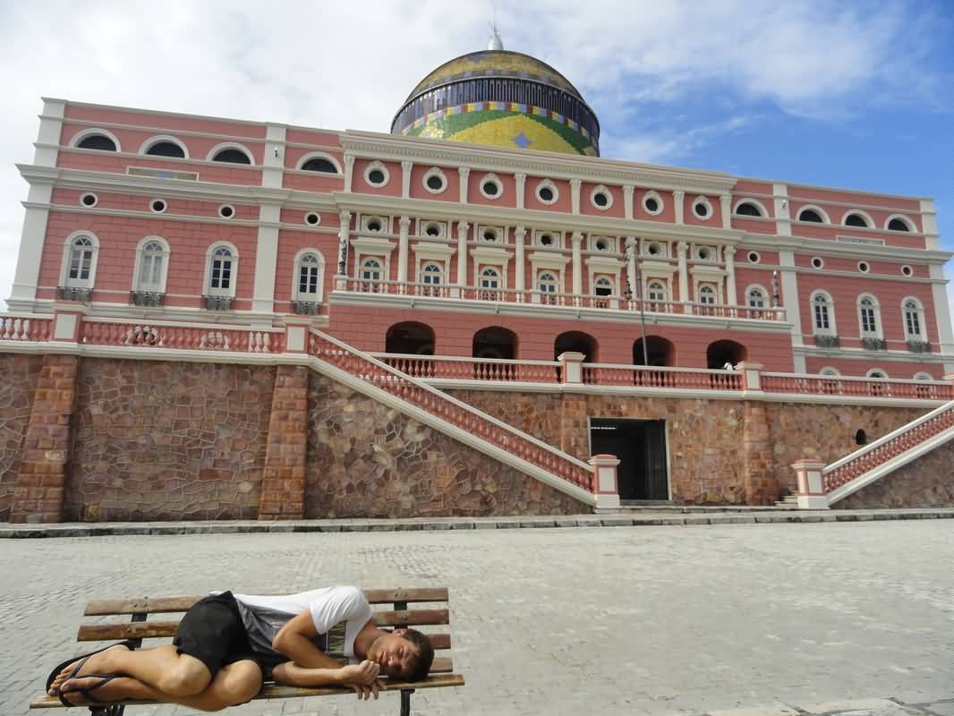 Man Sleeping On A Bench in Front Of Amazon Theatre In Manaus, Brazil