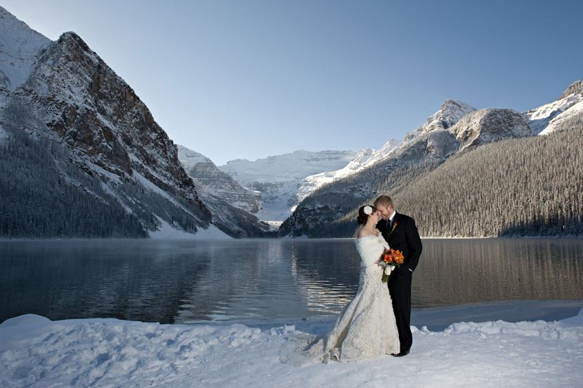 New Wedding Couple Standing On Lake Louise In Winter Season
