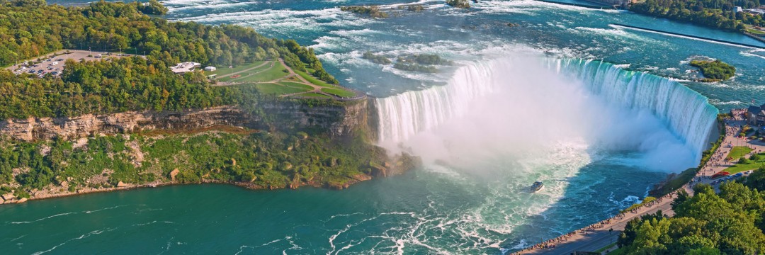 Niagara Falls Surrounding With Green Trees And Grass