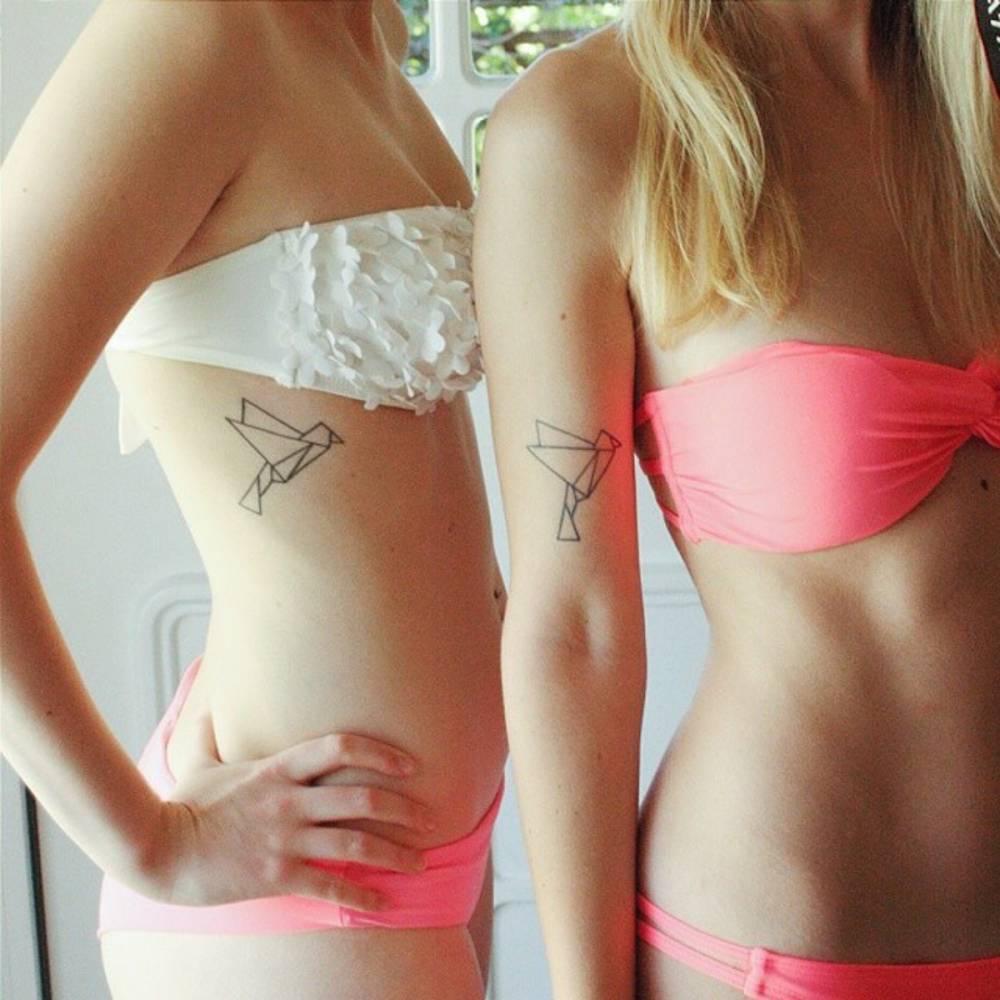 Paper Bird Matching Tattoos On Rib Cage And Arm