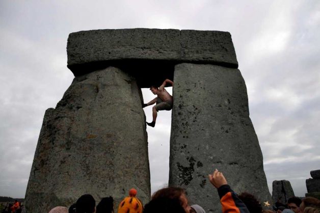 Protestor Climbing Stonehenge Rock