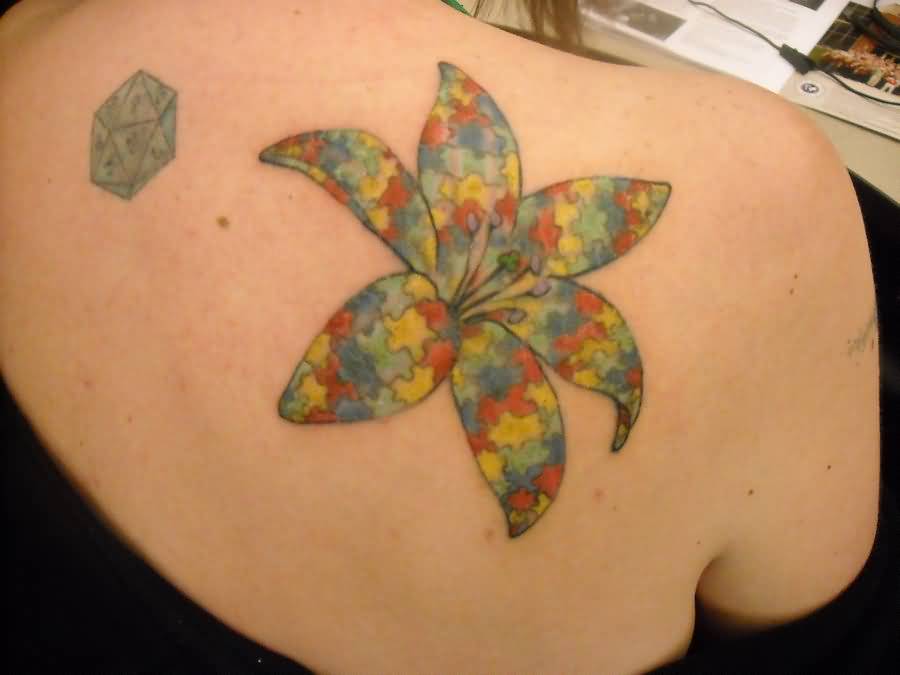 Rainbow Color Lily Puzzle Tattoo On Woman Back