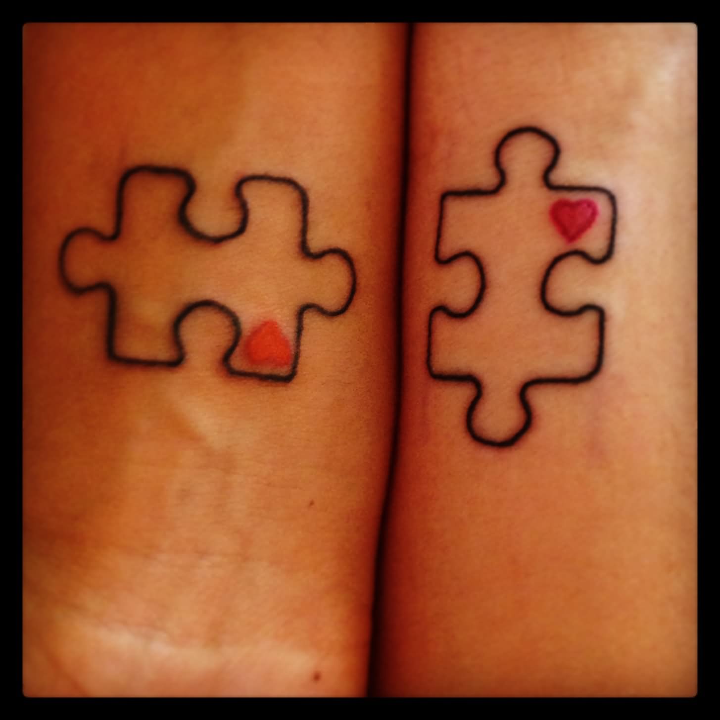 Red Tiny Heart In Matching Puzzle Tattoos On Both Wrists