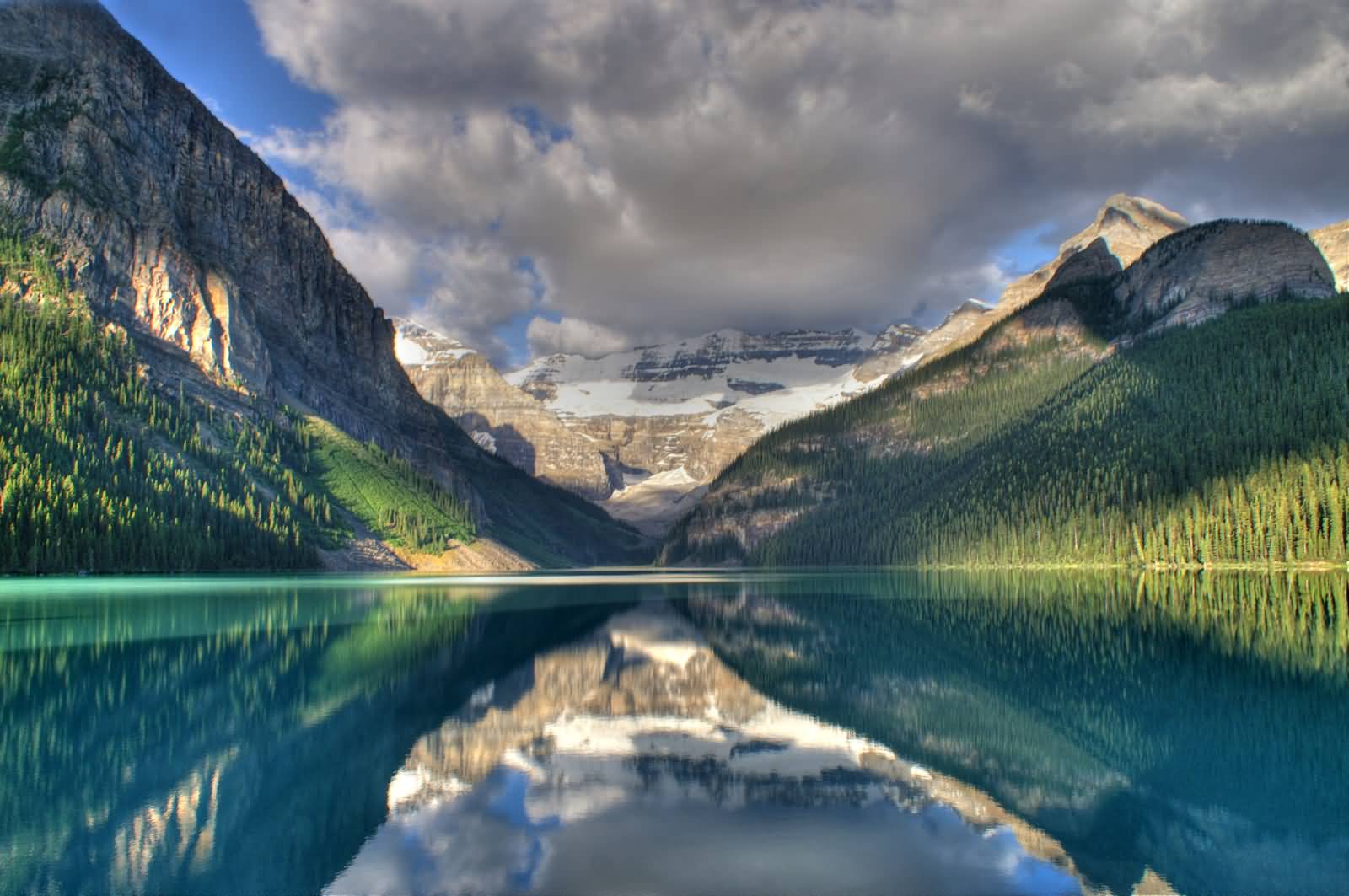 Reflection Of Clouds And Mountains In Lake Louise