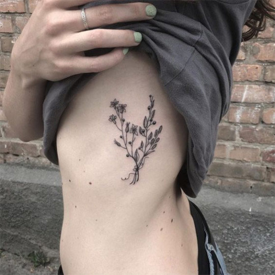 flower tattoo on rib cage