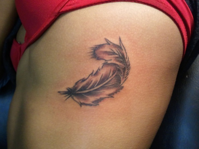 Small Rib Cage Feather Tattoo For Woman