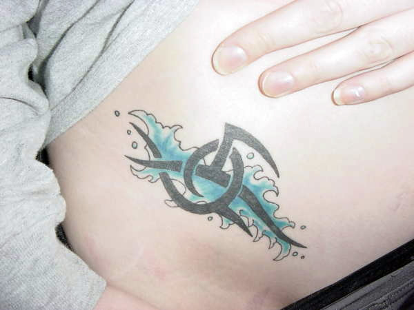 Small Water Tribal Tattoo On Girl Hip