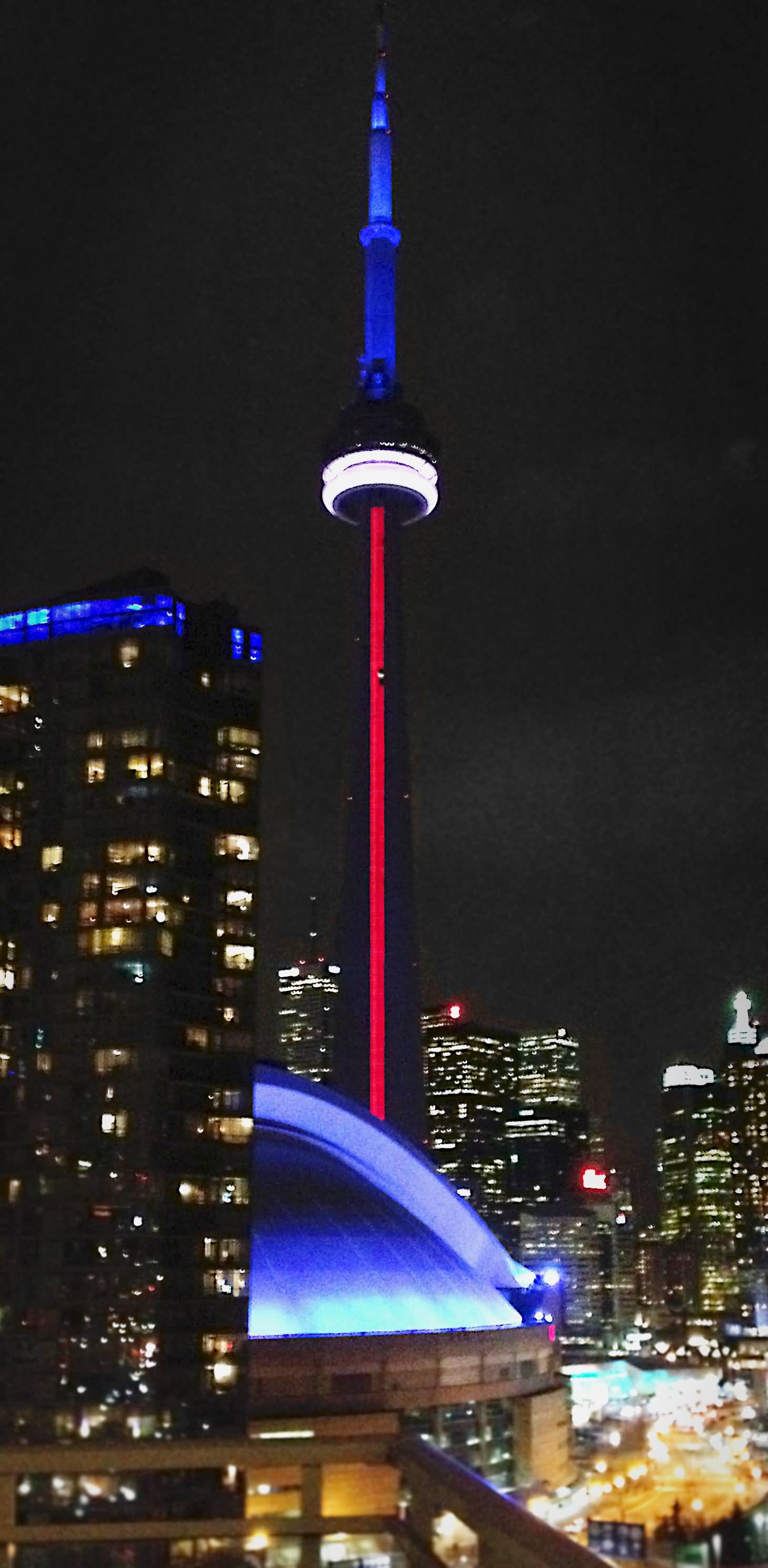 The CN Tower Illuminated In The Colors Of French Flag During Night