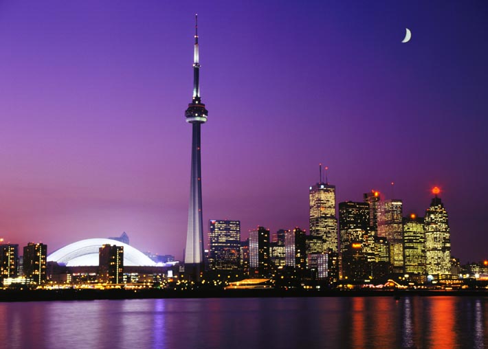 The CN Tower With Half Moon Lit Up At Night
