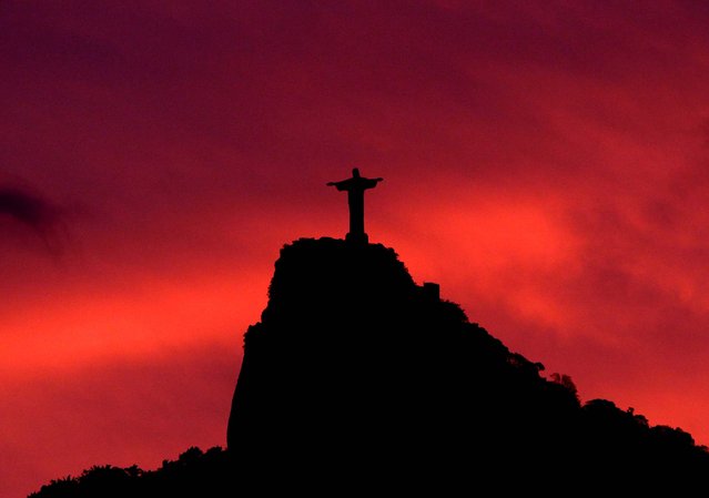 The Statue Of Christ The Redeemer Is Seen At Sunset