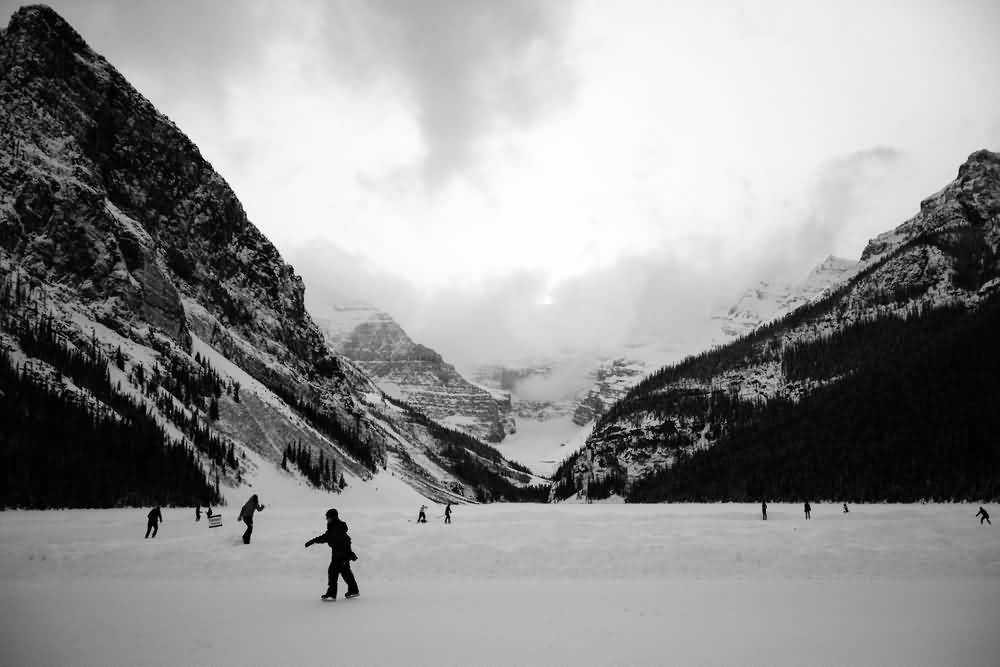 Tourists Skating On Frozen Lake Louise In Winter