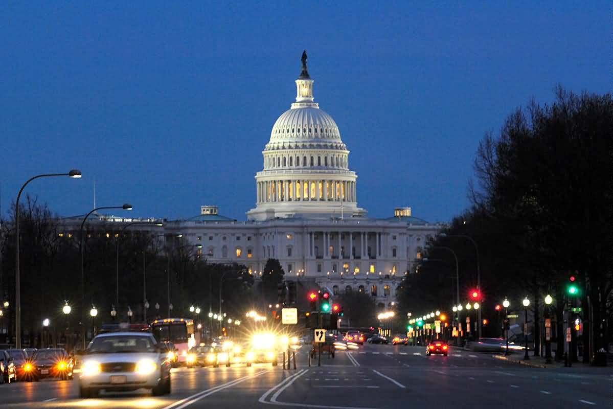 Traffic Passing Near The United States Capitol At Night