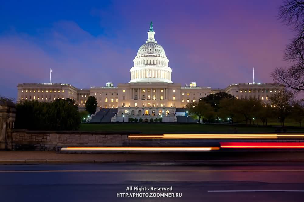 United States Capitol At Night With Lights Steaks From Cars