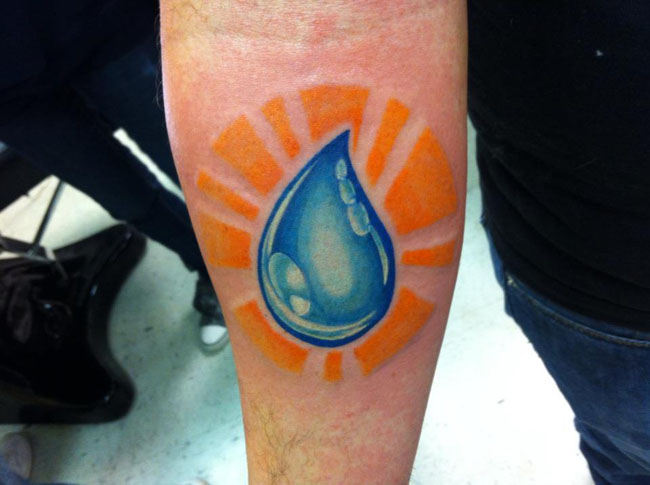 Water Drop In Orange Circle Tattoo On Forearm By Michael Douglas