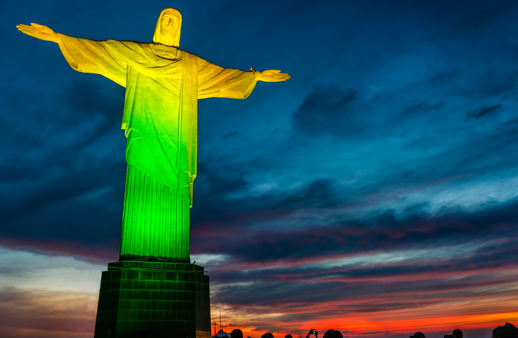 Yellow And Green Lights On The Christ the Redeemer Statue At Night