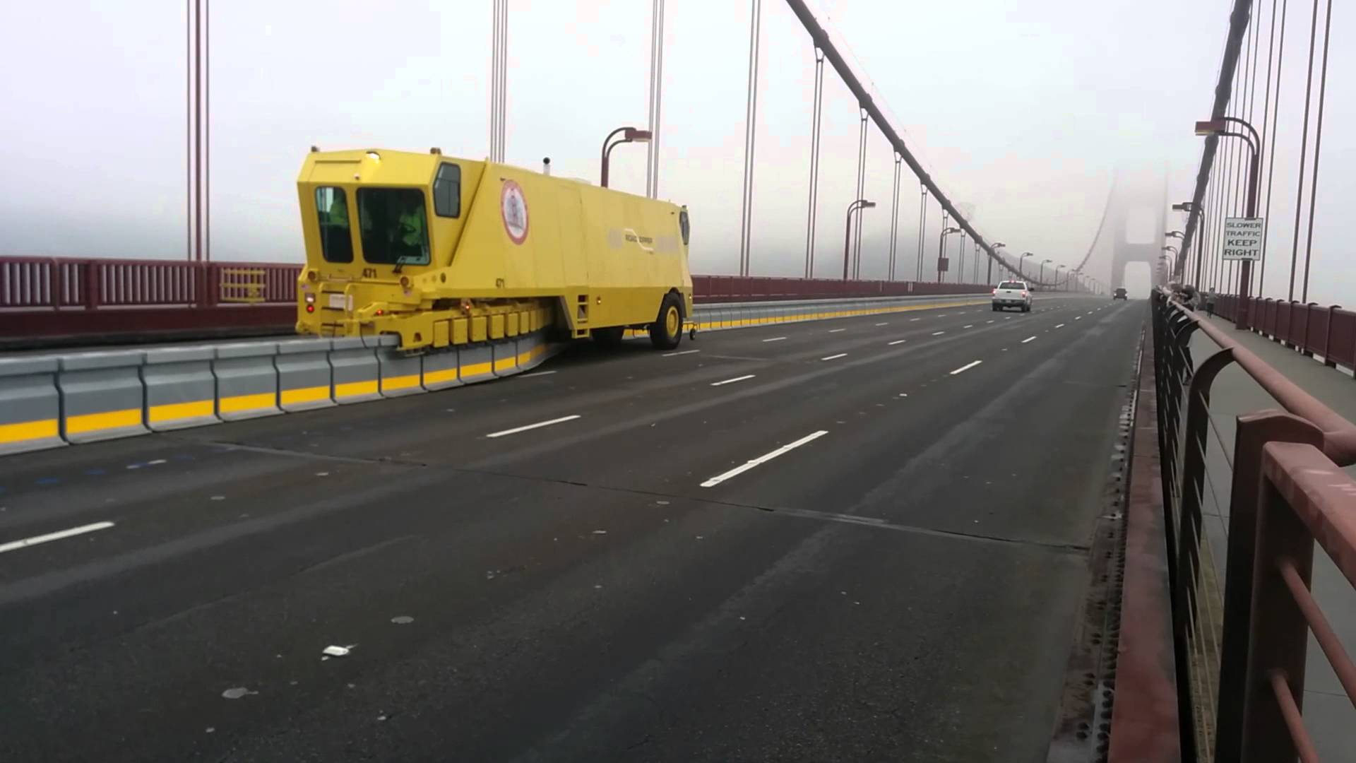 A Road Zipper Truck Moving On Golden Gate Bridge