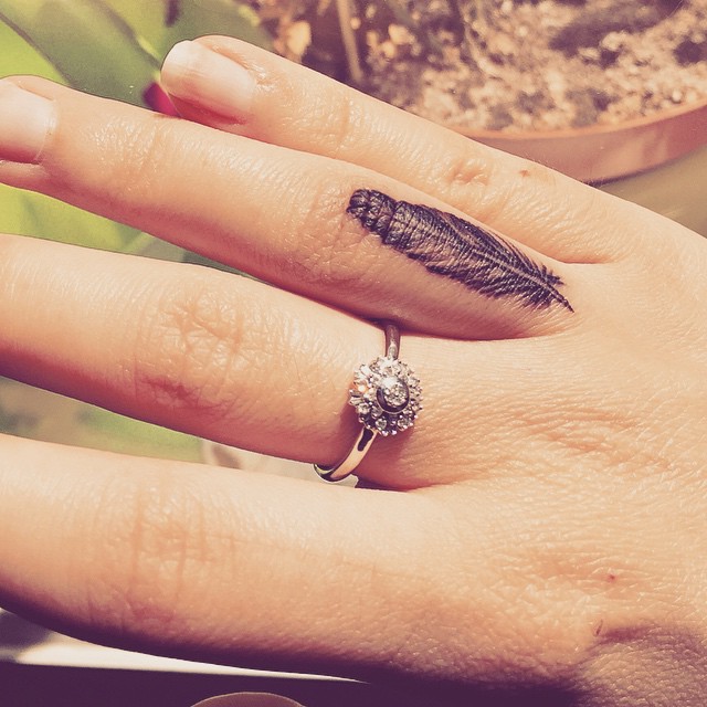 Amazing Feather Tattoo On Girl Finger