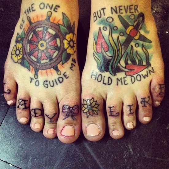 Anchor And Wheel With Wording Traditional Tattoos On Feet