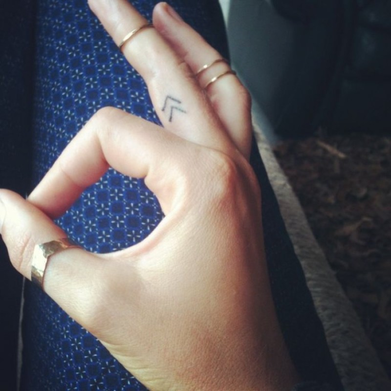 Arrow Symbol Tattoo On Inner Finger