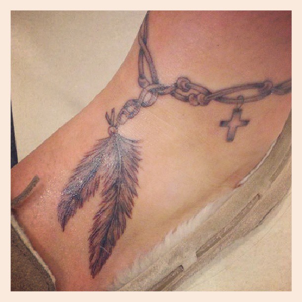 Awesome Cross Feathers Bracelet Tattoo On Ankle