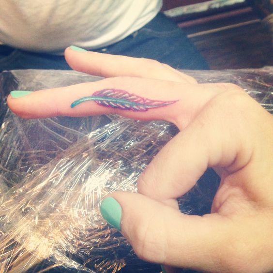 Awesome Girl With Feather Tattoo On Side Finger