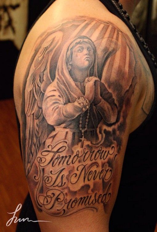 Awesome Praying Angel With Quote Tattoo On Man Shoulder