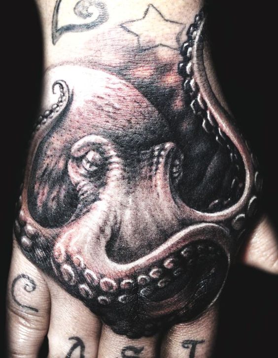 Awesome Realistic Octopus On Man Hand Tattoo