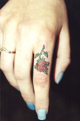 Beautiful Girl With Red Flower Tattoo On Finger