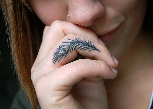 Beautiful Peacock Feather Tattoo On Side Finger