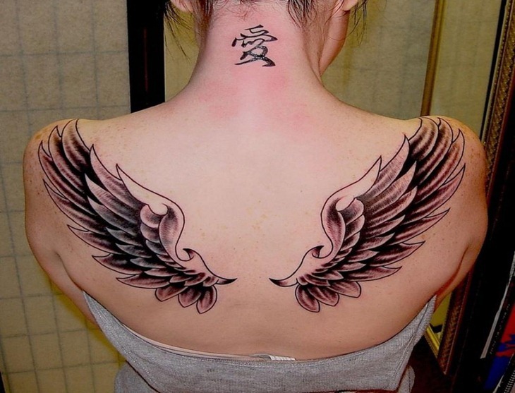 Black And Grey Angel Wings Tattoo On Girl Upper Back