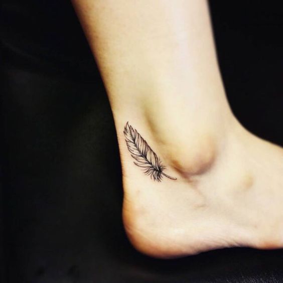Black And Grey Feather Tattoo On Side Ankle