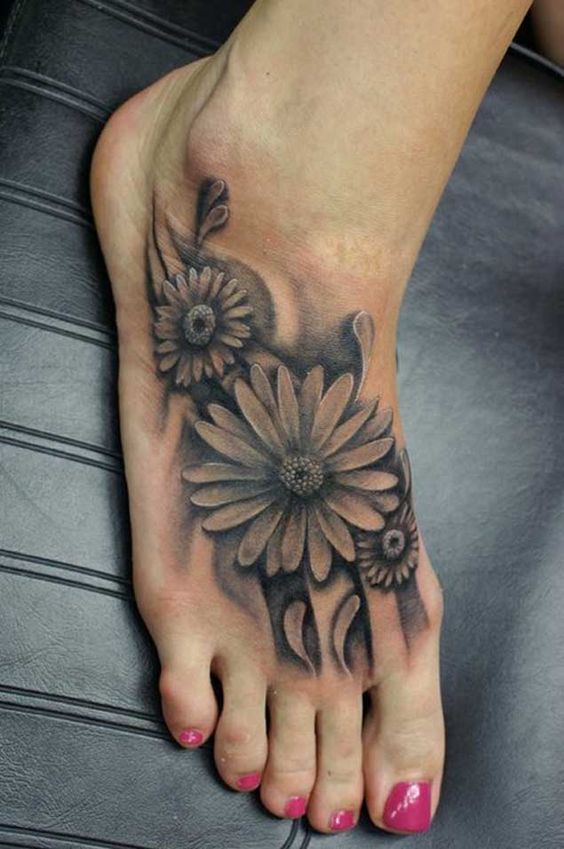Black And Grey Ink Daisy Flower Tattoo On Right Foot
