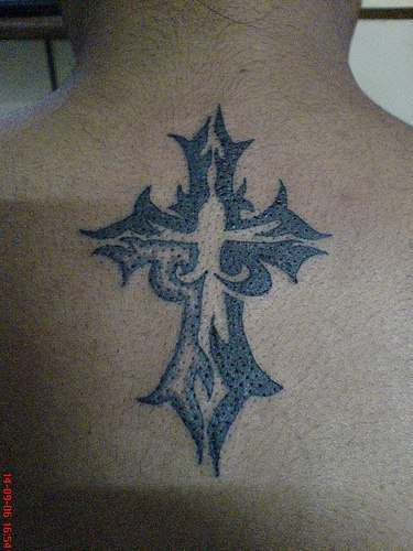 Black And Grey Tribal Christian Cross Tattoo On Upper Back