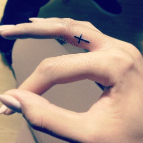 Black Cross Tattoo On Girl Side Finger