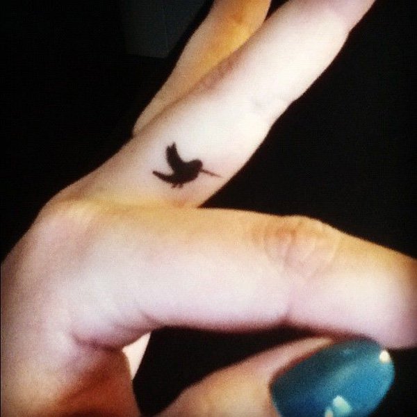 Black Ink Bird Tattoo On Side Finger