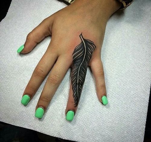 Black Ink Feather Tattoo On Girl Finger