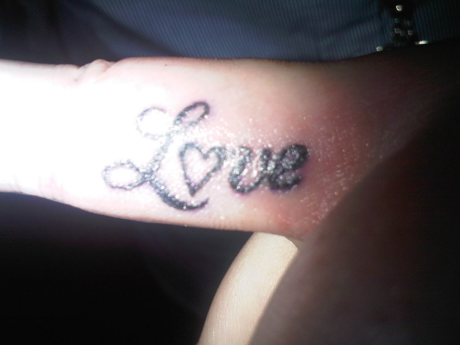 Black Ink Love Tattoo On Side Finger