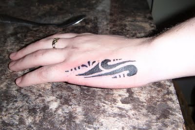 Black Ink Tribal Tattoo On Girl Left Hand