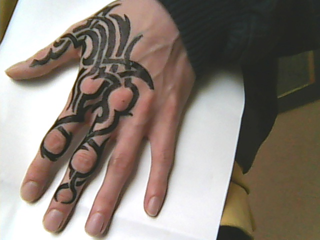 Black Ink Tribal Tattoo On Left Hand