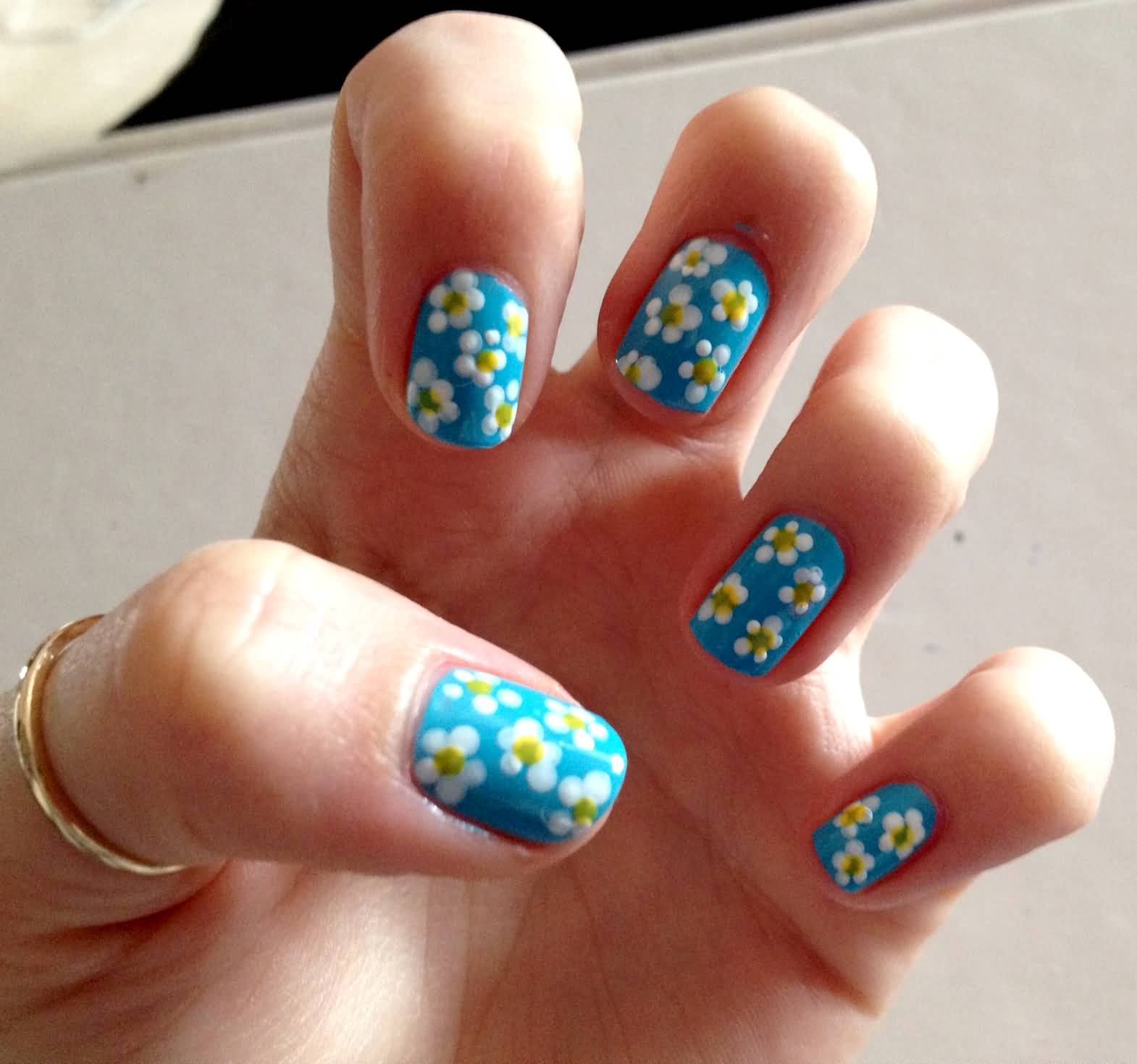 Blue Base Nails With White Spring Flowers Nail Art