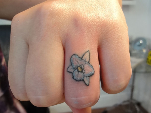 Blue Ink Flower Tattoo On Finger
